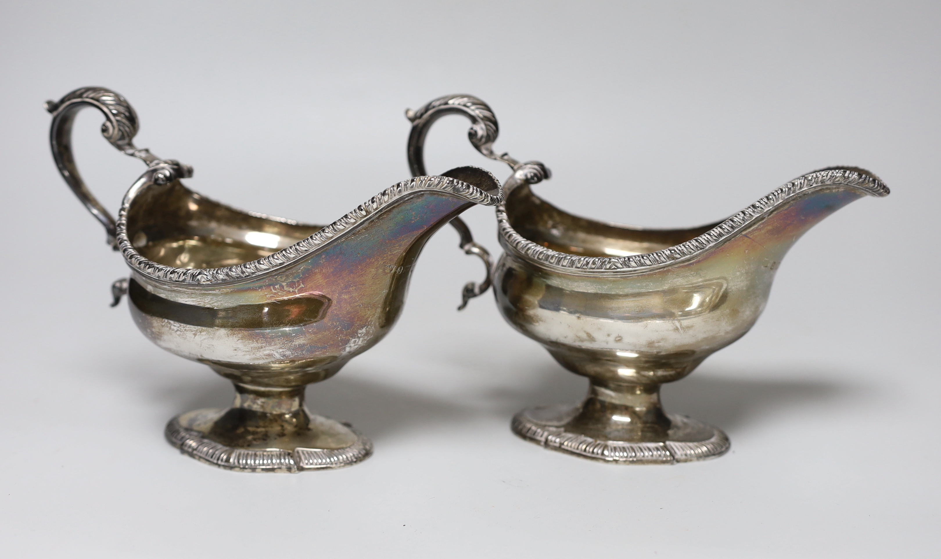 A pair of George VI silver pedestal sauceboats, with gadrooned borders, S. Blanckensee & Sons Ltd, Birmingham, 1937, length 19.8cm, 23.2oz.